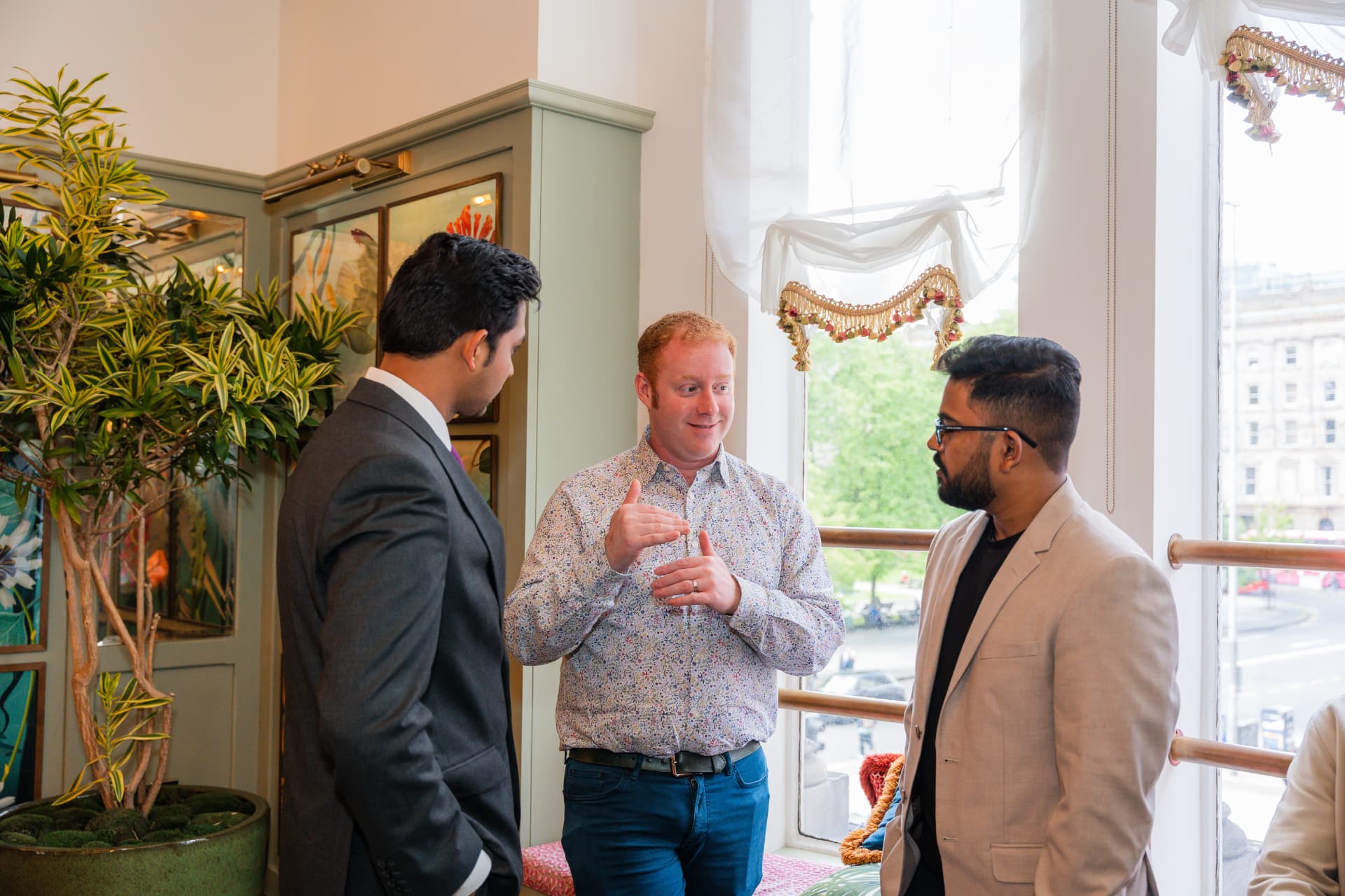 Tony McBride in conversation with two professionals at a career networking event in Belfast